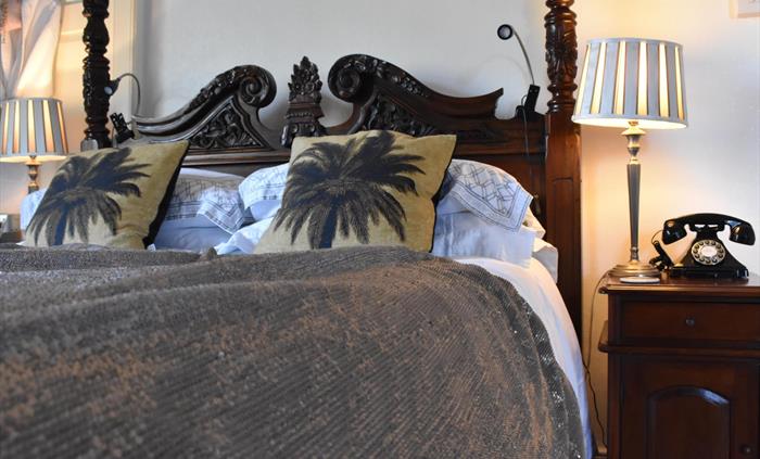 A large, luxurious room with a double aspect overlooking beautiful open countryside.The centrepiece is a king-size four-poster bed. And the indulgence
